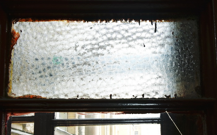 Большой пр. В.О., д. 62. Фрагмент рамы со стеклом "муранезе" в левом окне на площадке 2-3 этажа. Фото 2020
